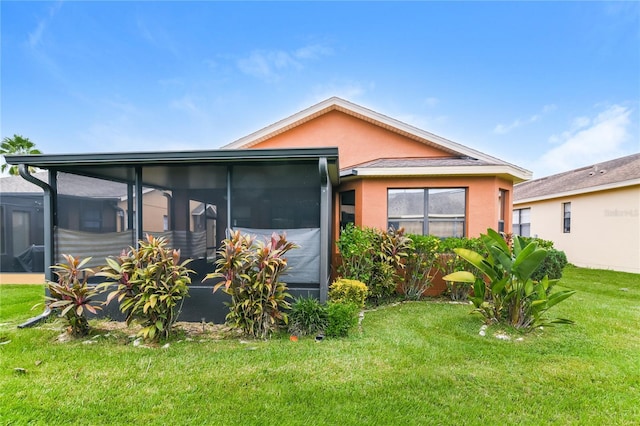 505 Millifiora Ln, Kissimmee, FL 34759 - view of front of property featuring a sunroom, stucco siding, and a front lawn