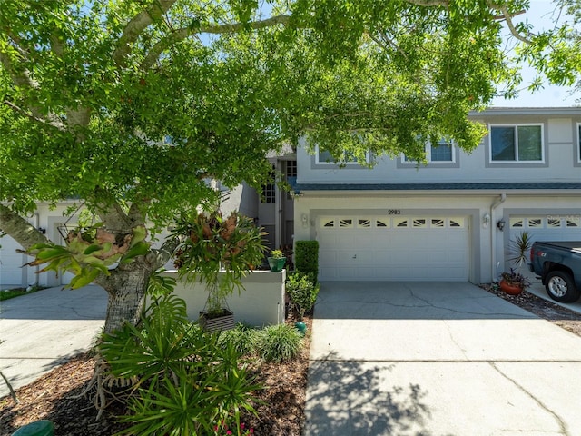 view of front of home featuring a garage, stucco siding, and concrete driveway
