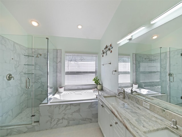 full bath featuring a shower stall, double vanity, a garden tub, and a sink