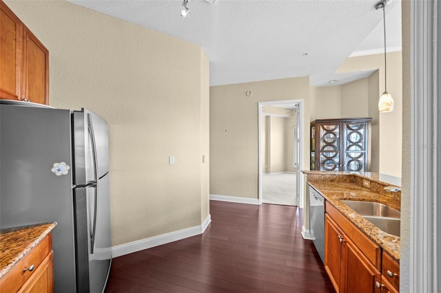 700 S Harbour Island Blvd Unit 813, Tampa, FL 33602 - kitchen featuring a sink, light stone countertops, appliances with stainless steel finishes, dark wood finished floors, and brown cabinets