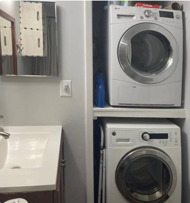 253 Rex Pl Unit B, Madeira Beach, FL 33708 - laundry area featuring stacked washing machine and dryer