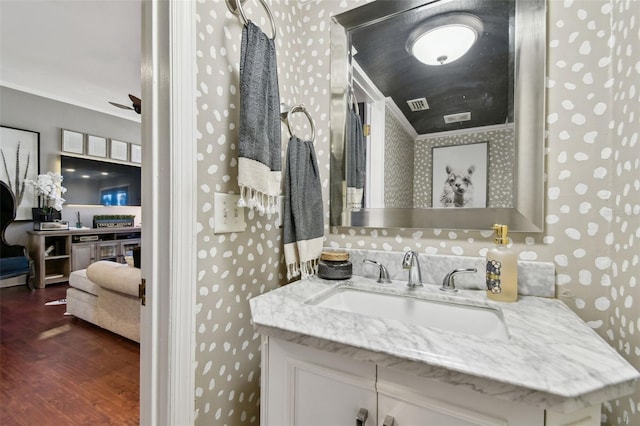 166 E Davis Blvd, Tampa, FL 33606 - bathroom featuring wood finished floors, vanity, wallpapered walls, and a ceiling fan