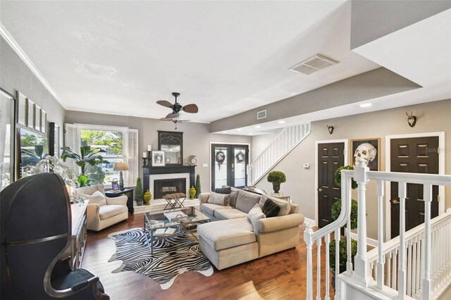 166 E Davis Blvd, Tampa, FL 33606 - living room with a ceiling fan, wood finished floors, stairway, a tile fireplace, and recessed lighting