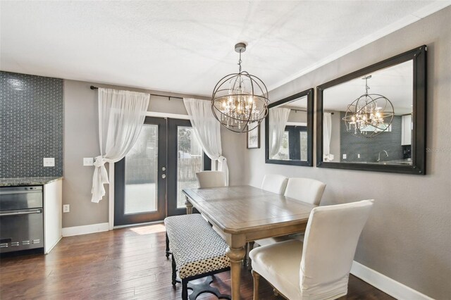 166 E Davis Blvd, Tampa, FL 33606 - dining area with a chandelier, french doors, baseboards, and dark wood-type flooring