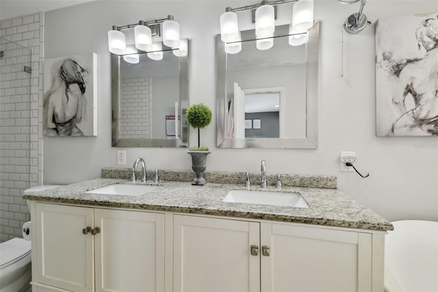 166 E Davis Blvd, Tampa, FL 33606 - full bathroom featuring toilet, double vanity, and a tile shower