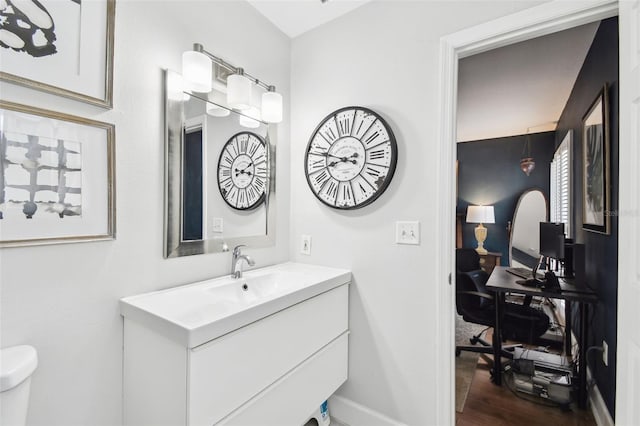 166 E Davis Blvd, Tampa, FL 33606 - bathroom featuring vanity, toilet, wood finished floors, and baseboards