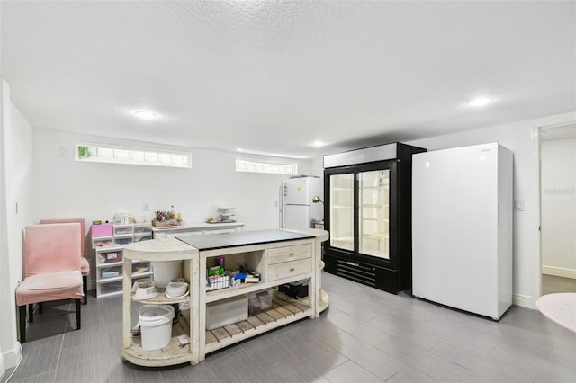 166 E Davis Blvd, Tampa, FL 33606 - kitchen featuring freestanding refrigerator, light countertops, and open shelves