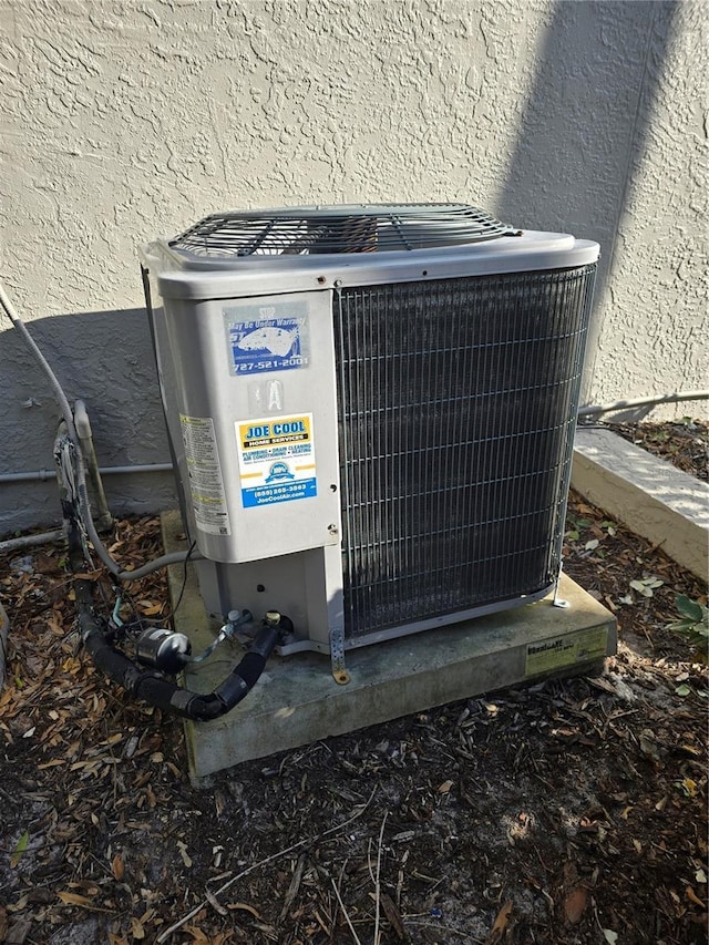 details featuring central air condition unit and stucco siding