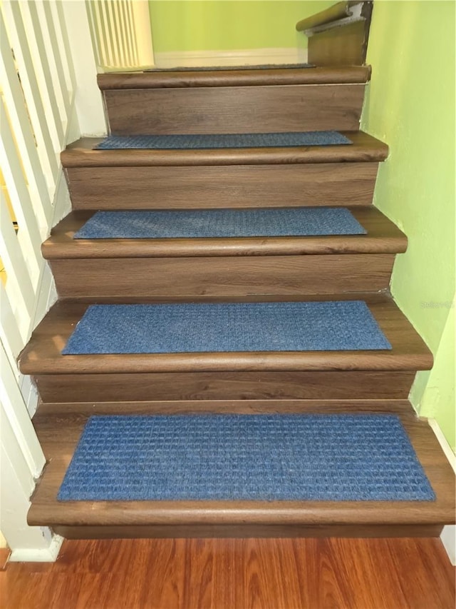 staircase featuring wood finished floors
