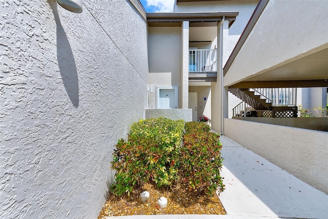 entrance to property featuring stucco siding