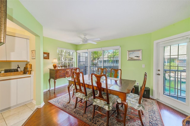 dining space with ceiling fan, light wood-style floors, and baseboards
