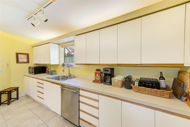 kitchen with white cabinets, light countertops, a sink, and appliances with stainless steel finishes