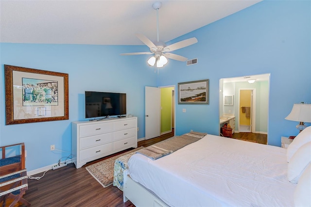 bedroom featuring dark wood-type flooring, visible vents, vaulted ceiling, and connected bathroom