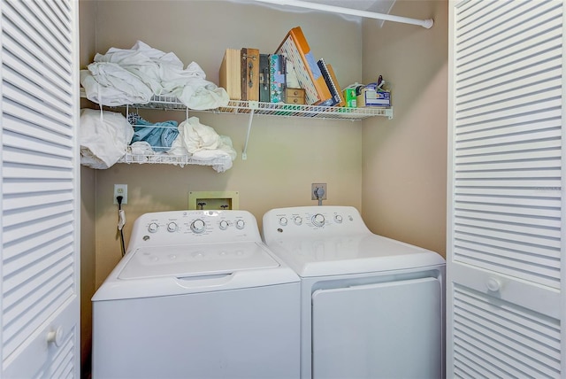 washroom featuring washer and clothes dryer and laundry area