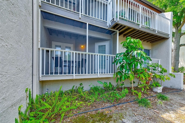 view of home's exterior featuring a balcony and stucco siding