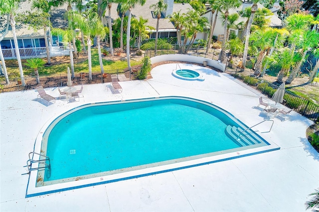 pool with fence and a patio