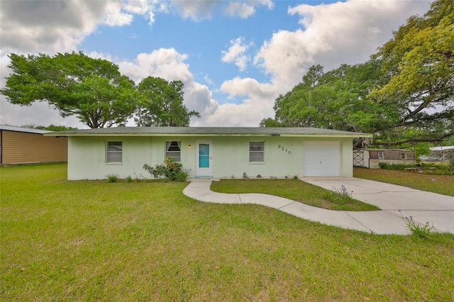 9210 Lehall Sq W, Lakeland, FL 33810 - ranch-style home featuring stucco siding, an attached garage, driveway, and a front lawn