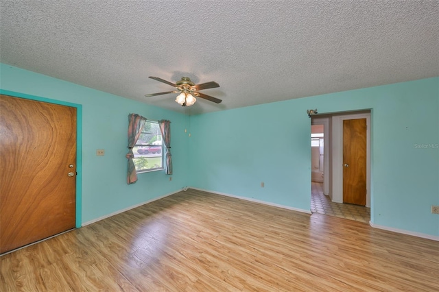 9210 Lehall Sq W, Lakeland, FL 33810 - spare room featuring light wood-style floors, ceiling fan, a textured ceiling, and baseboards