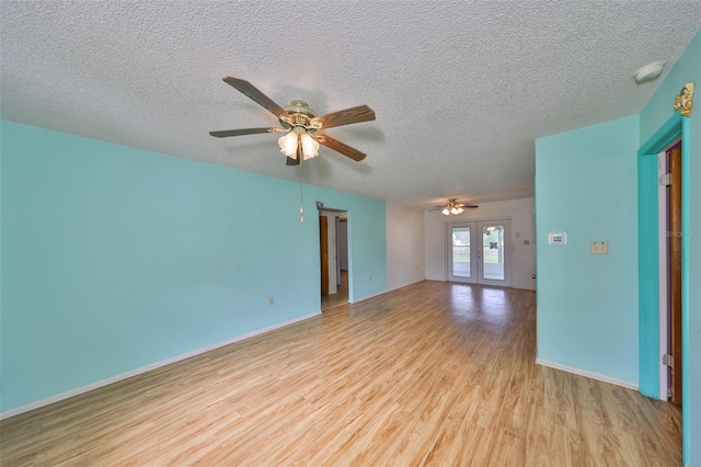 9210 Lehall Sq W, Lakeland, FL 33810 - empty room featuring light wood-type flooring, ceiling fan, french doors, a textured ceiling, and baseboards