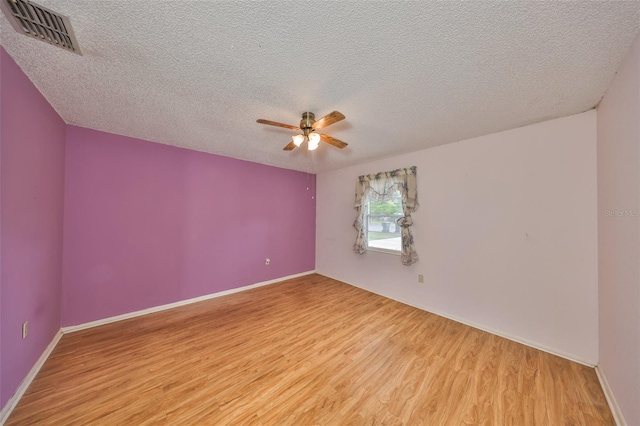 9210 Lehall Sq W, Lakeland, FL 33810 - unfurnished room with light wood-style floors, ceiling fan, a textured ceiling, and baseboards