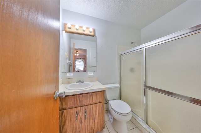 9210 Lehall Sq W, Lakeland, FL 33810 - full bathroom with an enclosed shower, tile patterned flooring, vanity, toilet, and a textured ceiling