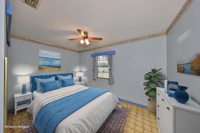 9210 Lehall Sq W, Lakeland, FL 33810 - bedroom with light floors, a textured ceiling, a ceiling fan, and ornamental molding