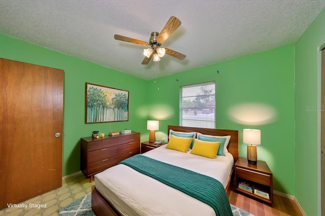 9210 Lehall Sq W, Lakeland, FL 33810 - bedroom with baseboards, a textured ceiling, and a ceiling fan