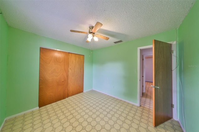 9210 Lehall Sq W, Lakeland, FL 33810 - unfurnished bedroom featuring a closet, baseboards, a textured ceiling, ceiling fan, and light floors