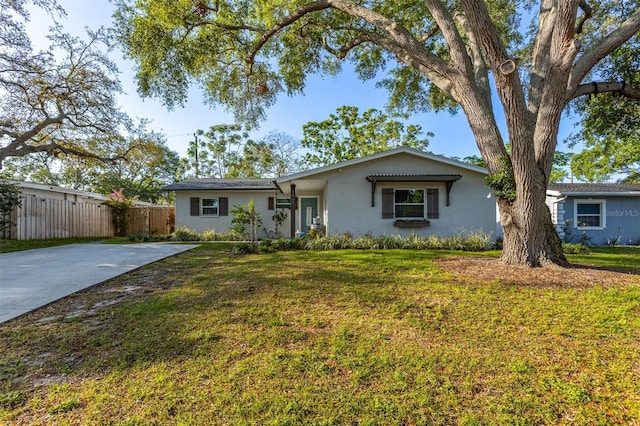1543 Gentry St, Clearwater, FL 33755 - ranch-style house featuring concrete driveway, stucco siding, a front yard, and fence