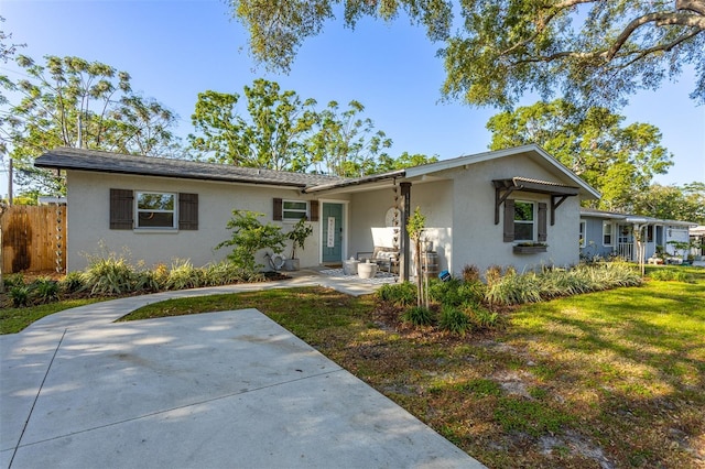 1543 Gentry St, Clearwater, FL 33755 - ranch-style home featuring a patio, fence, and stucco siding