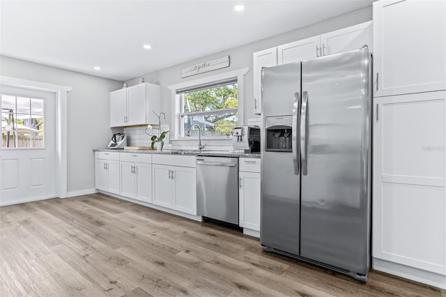 1543 Gentry St, Clearwater, FL 33755 - kitchen featuring a sink, light wood finished floors, stainless steel appliances, recessed lighting, and white cabinetry