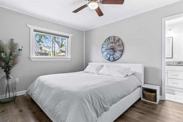 1543 Gentry St, Clearwater, FL 33755 - bedroom with connected bathroom, ceiling fan, baseboards, and wood finished floors