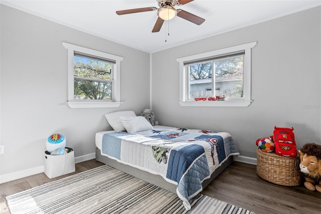 1543 Gentry St, Clearwater, FL 33755 - bedroom featuring baseboards, ceiling fan, multiple windows, and wood finished floors