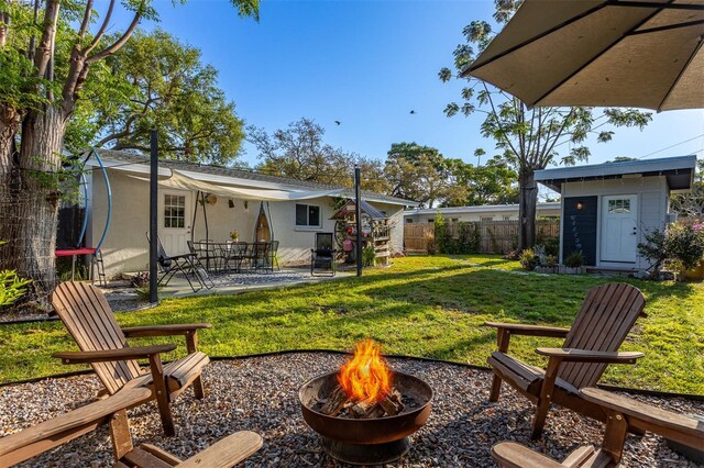 1543 Gentry St, Clearwater, FL 33755 - view of yard featuring a patio, fence, and an outdoor fire pit