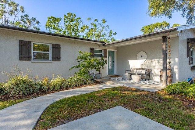1543 Gentry St, Clearwater, FL 33755 - property entrance with a patio and stucco siding