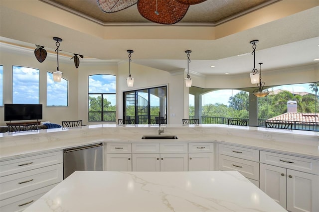 kitchen with stainless steel dishwasher, crown molding, a sink, and white cabinets