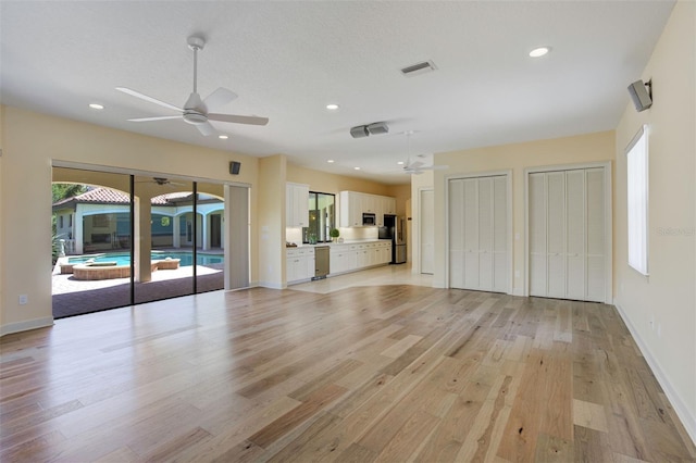 unfurnished living room featuring light wood-type flooring, baseboards, visible vents, ceiling fan, and recessed lighting