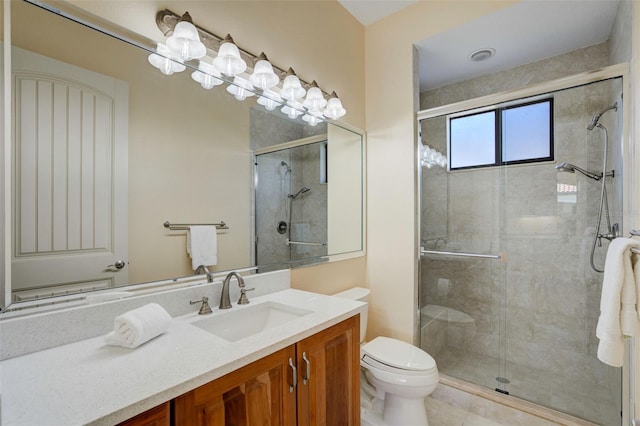 full bathroom with a stall shower, toilet, tile patterned flooring, and vanity