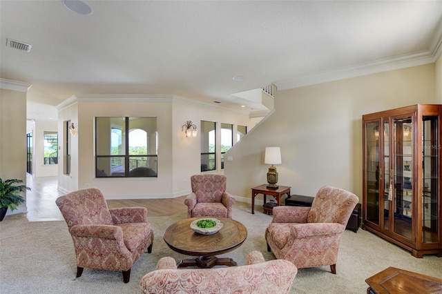 carpeted living room with baseboards, visible vents, and ornamental molding