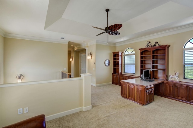 office with a raised ceiling, light carpet, baseboards, ceiling fan, and ornamental molding