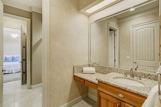bathroom with ensuite bathroom, crown molding, baseboards, vanity, and tile patterned flooring