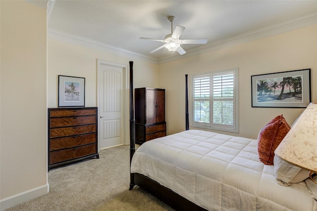 bedroom with a ceiling fan, carpet floors, ornamental molding, and baseboards