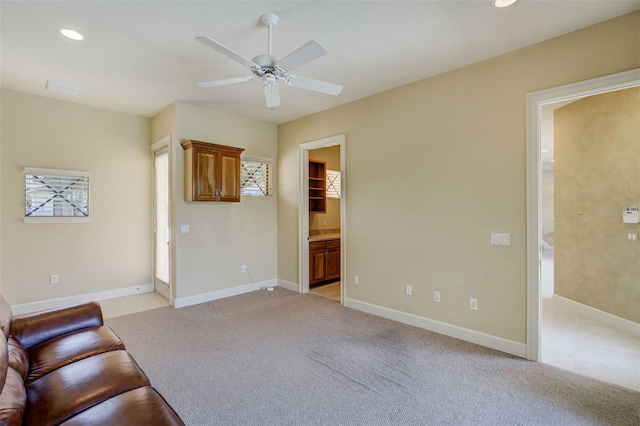 unfurnished living room with a ceiling fan, baseboards, plenty of natural light, light colored carpet, and recessed lighting
