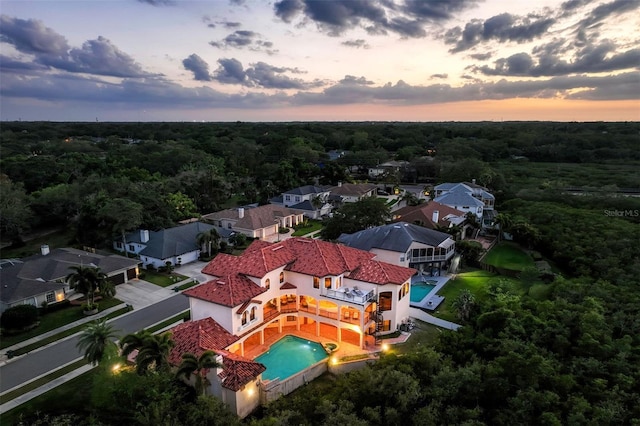 birds eye view of property featuring a residential view and a view of trees