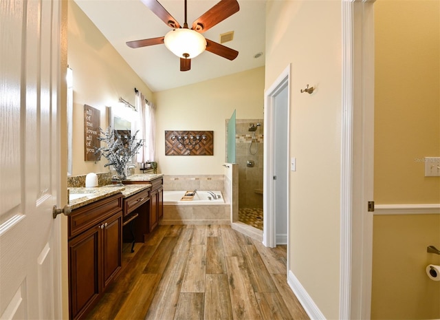 bathroom featuring visible vents, a tile shower, ceiling fan, vanity, and a garden tub