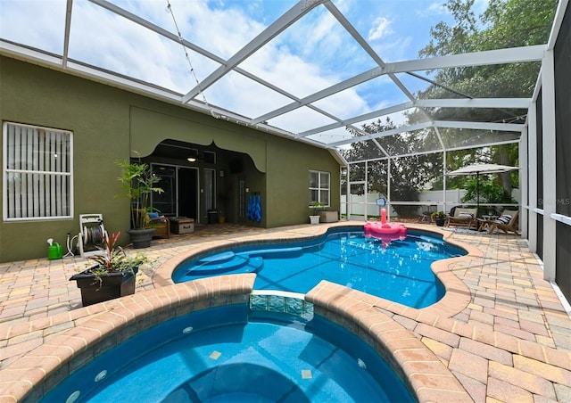view of pool featuring a patio area and a pool with connected hot tub