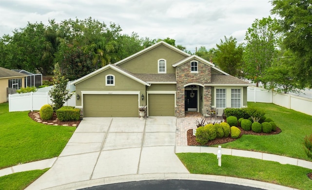 view of front of home featuring stucco siding, driveway, stone siding, an attached garage, and a front lawn