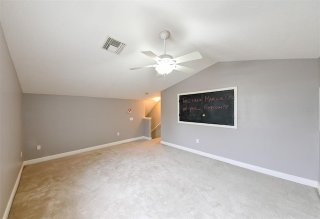 interior space featuring ceiling fan, baseboards, vaulted ceiling, and visible vents