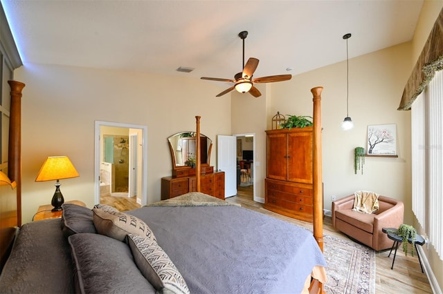 bedroom with visible vents, baseboards, light wood-type flooring, and connected bathroom