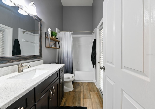 bathroom featuring shower / bath combo, vanity, toilet, and wood finished floors